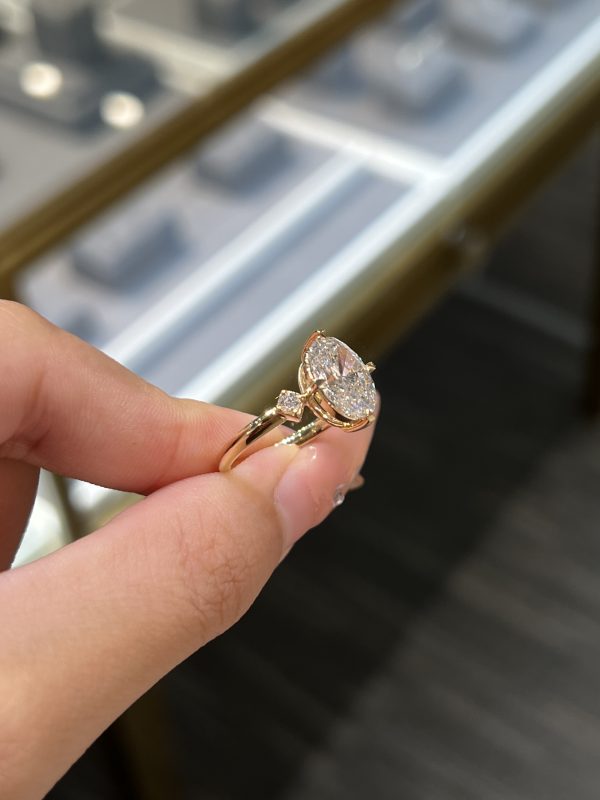 Oval Cut Lab Grown Diamond Three-Stone Engagement Ring in 18K Yellow Gold